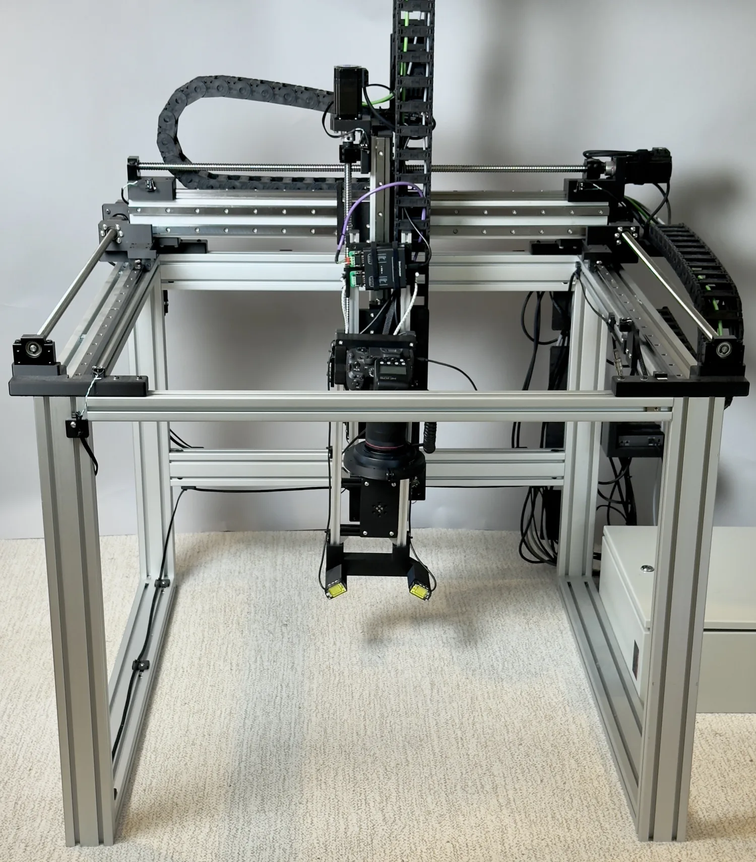 Front view of the OpenDerm gantry with its four degrees of freedom marked: the X long-travel truck and Y cross-travel beam, the Z vertical column, and the RX pan axis at the sensor head.